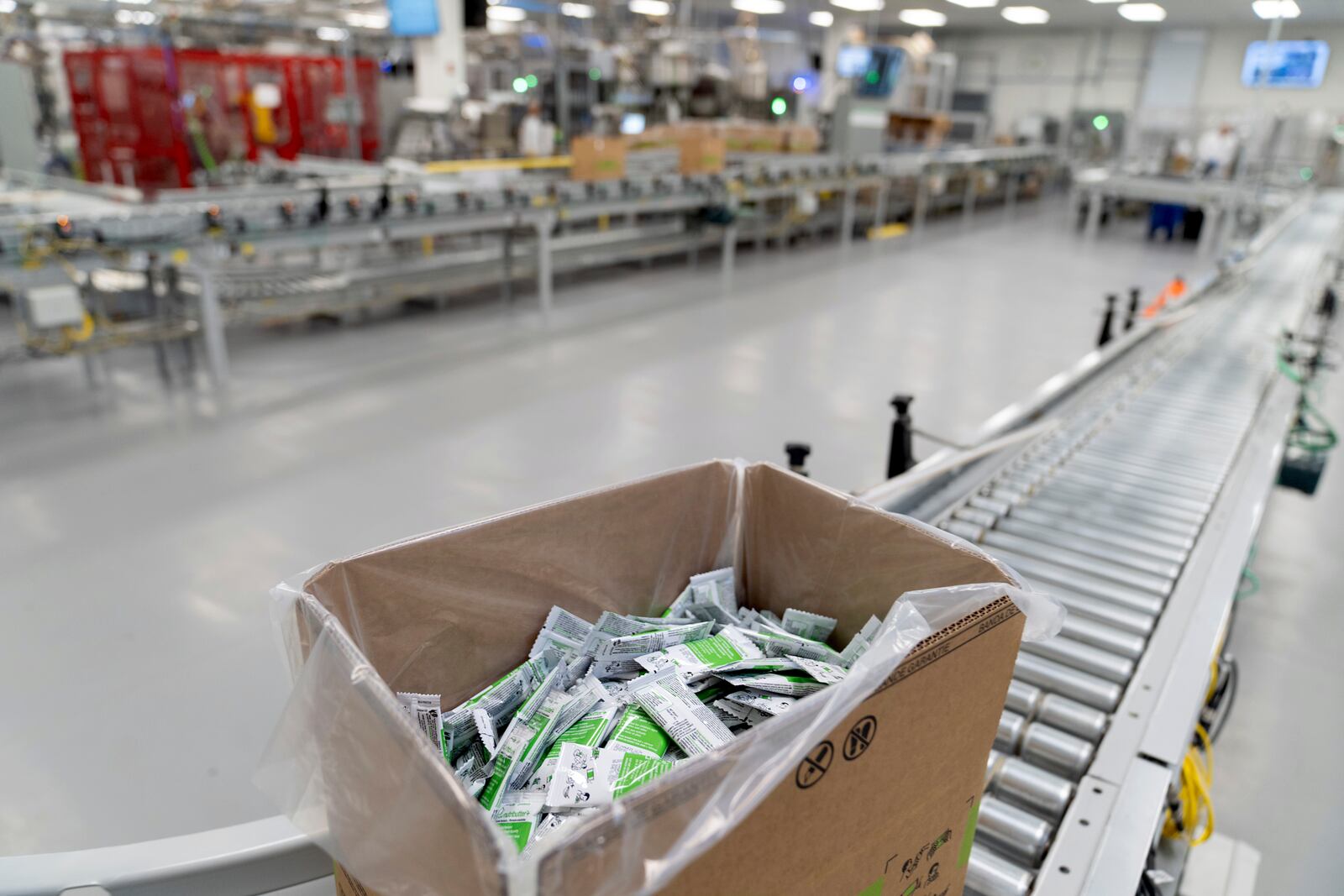 A conveyer belt usually loaded with boxes moves a single box of Plumpy'Nut, a nutritional lifesaving peanut paste sent to malnourished children worldwide, at Edesia Nutrition, Friday, March 14, 2025, in North Kingstown, R.I. (AP Photo/David Goldman)