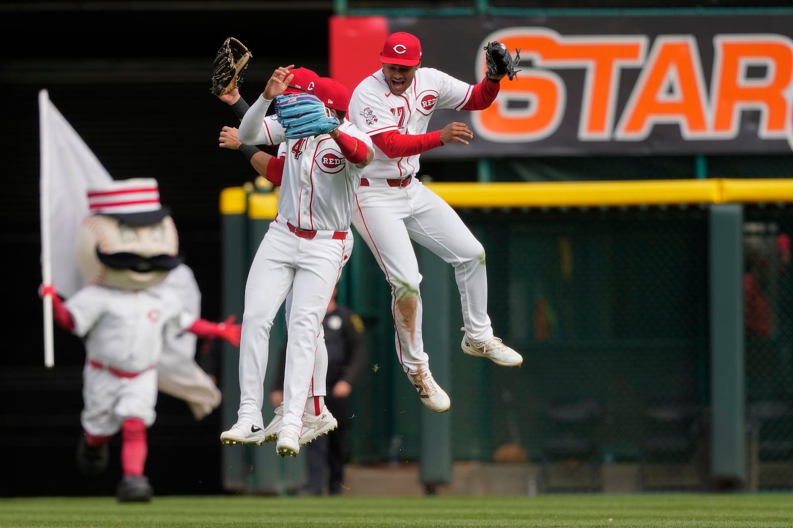 Cincinnati Reds' Dane Myers, right, Noelvi Marte (4), left, and TJ Friedl, behind, leaps to celebrate after winning a baseball game against the Boston Red Sox in Cincinnati, Sunday, March 29, 2026. (AP Photo/Carolyn Kaster)