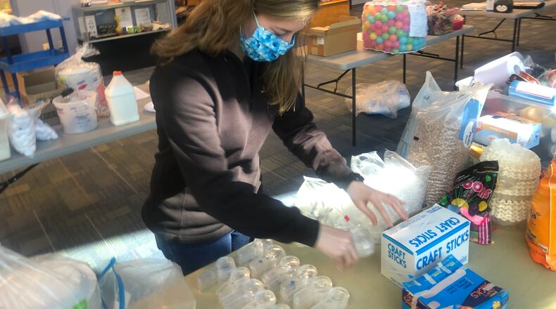 The Boonshoft Museum of Discovery closed to the public on May 15. Education Coordinator Alyssa  McKinney helps assemble Camp in a Box kits.