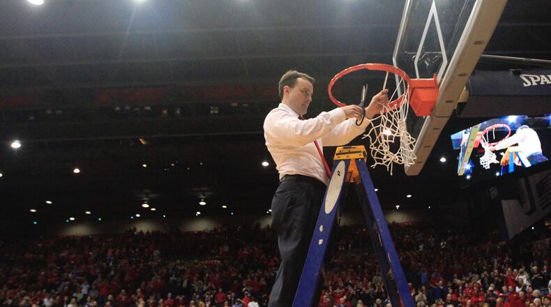 Dayton's Archie Miller cuts down the net after a victory against Virginia Commonwealth on March 1, 2017, at UD Arena.