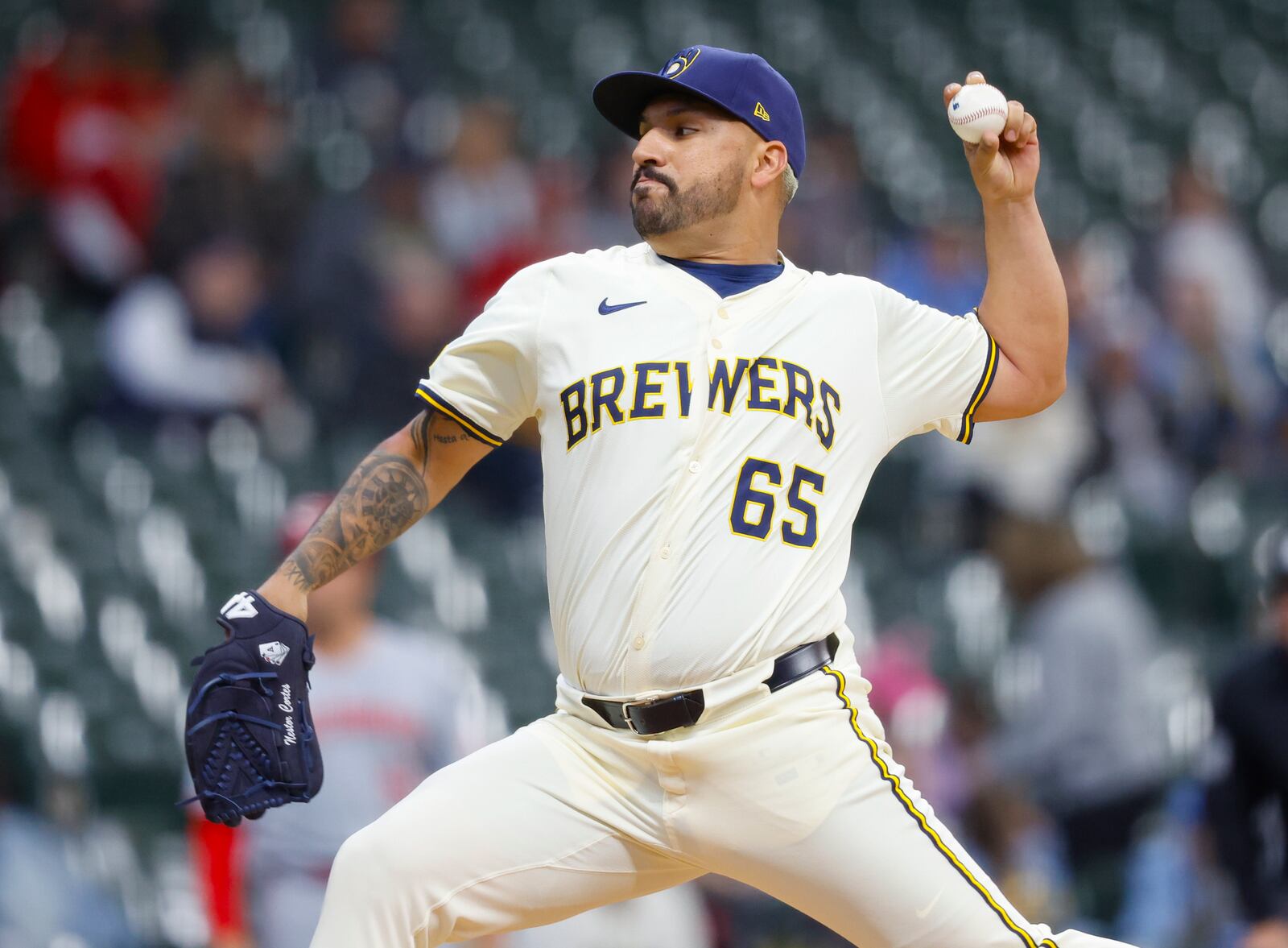 Milwaukee Brewers starting pitcher Néstor Cortes (65) throws to the Cincinnati Reds during the first inning of a baseball game, Thursday, April 3, 2025, in Milwaukee. (AP Photo/Jeffrey Phelps)