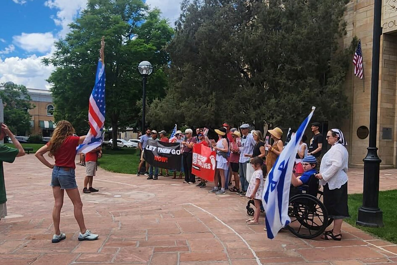 Demonstrators with the group Run for Their Lives gather as they host Sunday's walk in Boulder, Colo., before people were injured in a fiery attack, Sunday, June 1, 2025. (Lisa Turnquist via AP)