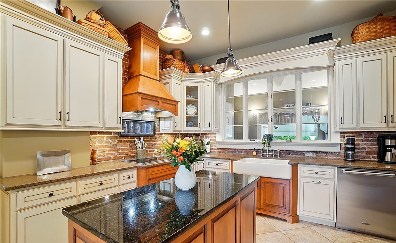 The updated kitchen has tile flooring, granite countertops and newer wood cabinets.