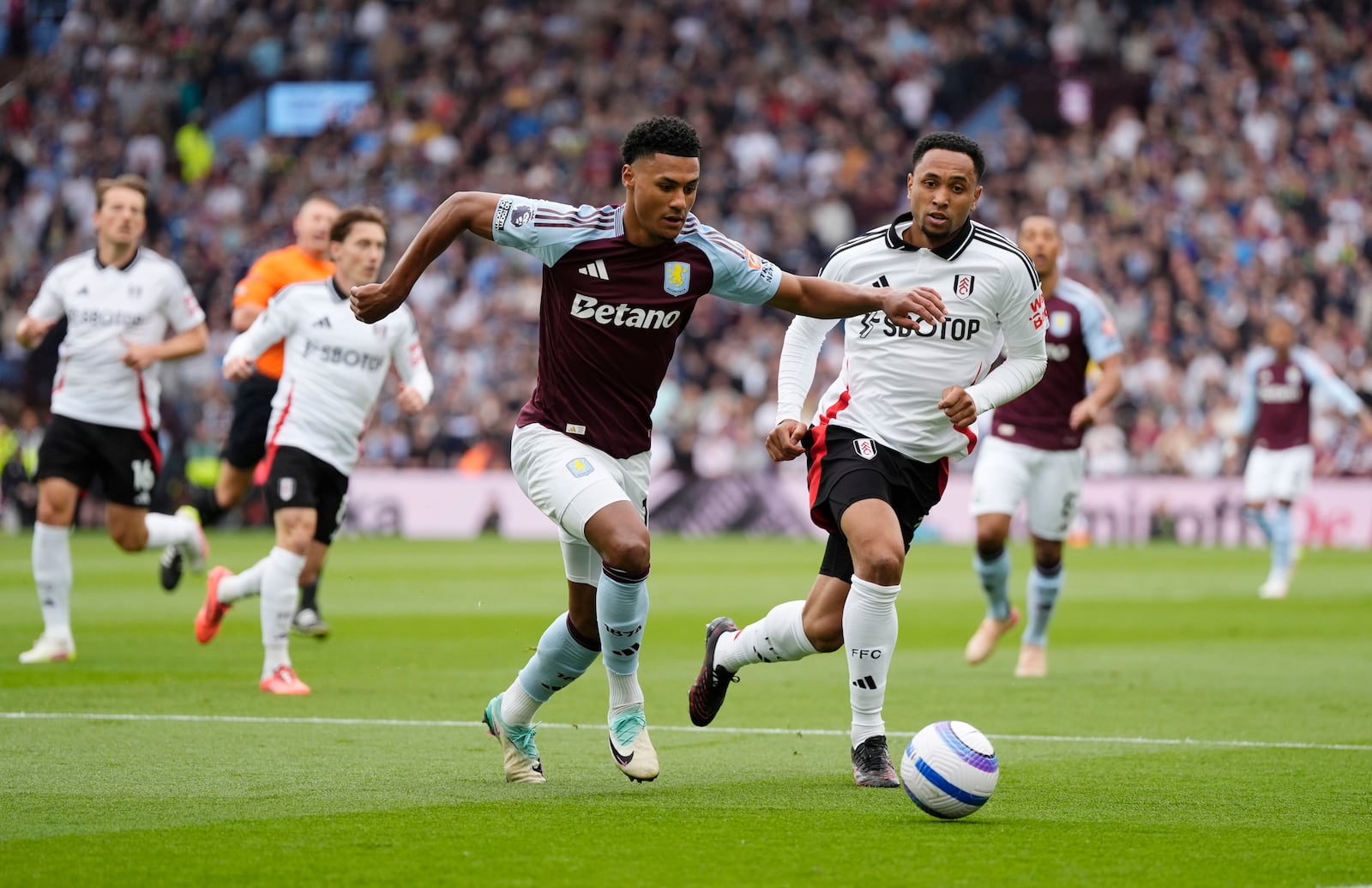 Aston Villa's Ollie Watkins, centre, and Fulham's Kenny Tete battle for the ball during the English Premier League soccer match between Aston Villa and Fulham at Villa Park, Birmingham, England, Saturday, May 3, 2025. (Nick Potts/PA via AP)
