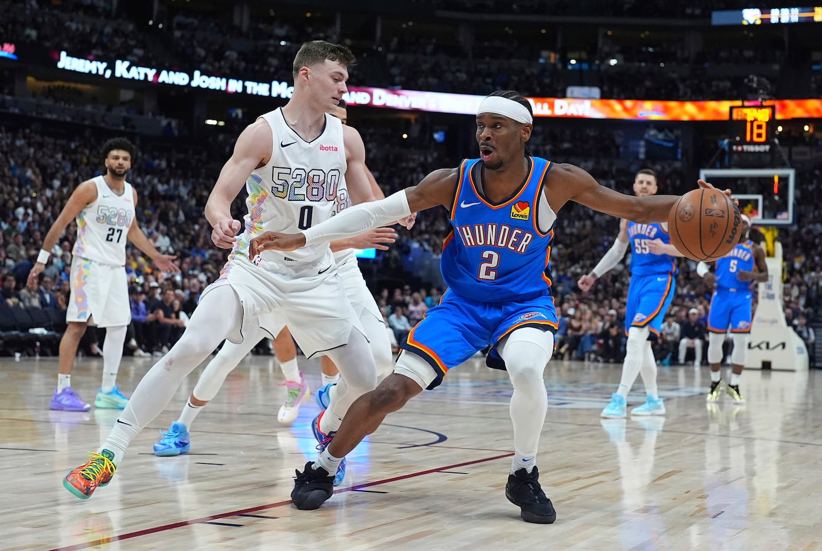 Oklahoma City Thunder guard Shai Gilgeous-Alexander, right, drives to the basket as Denver Nuggets guard Christian Braun defends in the second half of Game 6 in the Western Conference semifinals of the NBA basketball playoffs Thursday, May 15, 2025, in Denver. (AP Photo/David Zalubowski)