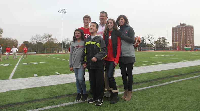 Wittenberg’s Joe Fincham, back center, poses for a photo with his wife Rita, right, and kids Annie, left, Mack, back left, and Samantha, second from right, after earning his 200th career victory in a game against Ohio Wesleyan on Saturday, Nov. 4, 2017, at Edwards-Maurer Field in Springfield. David Jablonski/Staff