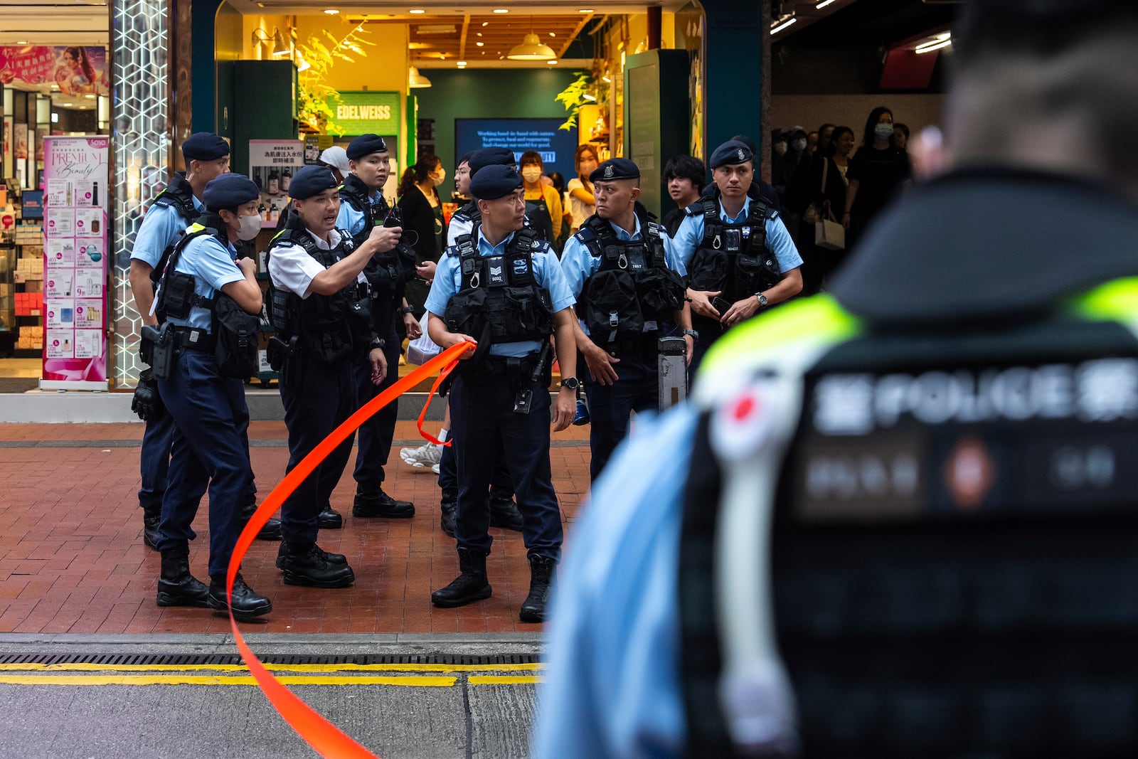 Police officers stand guard in the Causeway Bay area on the 36th anniversary of China's Tiananmen Square crackdown, in Hong Kong, Wednesday, June 4, 2025. (AP Photo/Chan Long Hei)