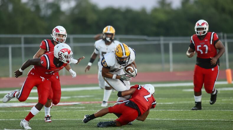 Springfield's Jamil Miller is tackled by Trotwood-Madison's Armani Rogers on Friday, Sept. 1, 2023, in Trotwood. David Jablonski/Staff