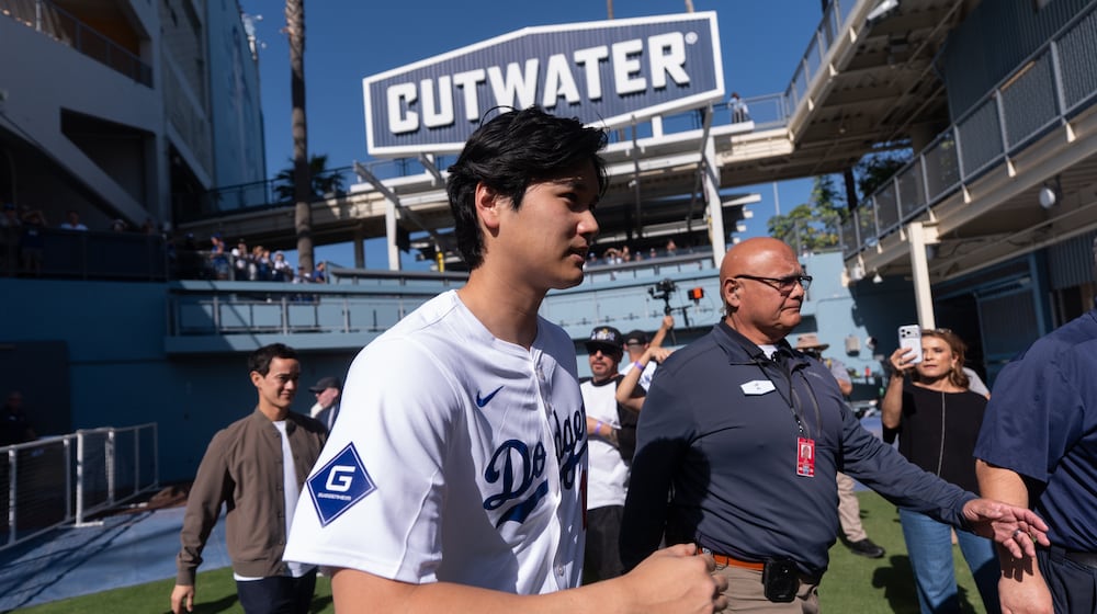 Los Angeles Dodgers two-way player Shohei Ohtani arrives to talk to reporters during DodgerFest at Dodger Stadium in Los Angeles, Saturday, Jan. 31, 2026. (AP Photo/Jae C. Hong)