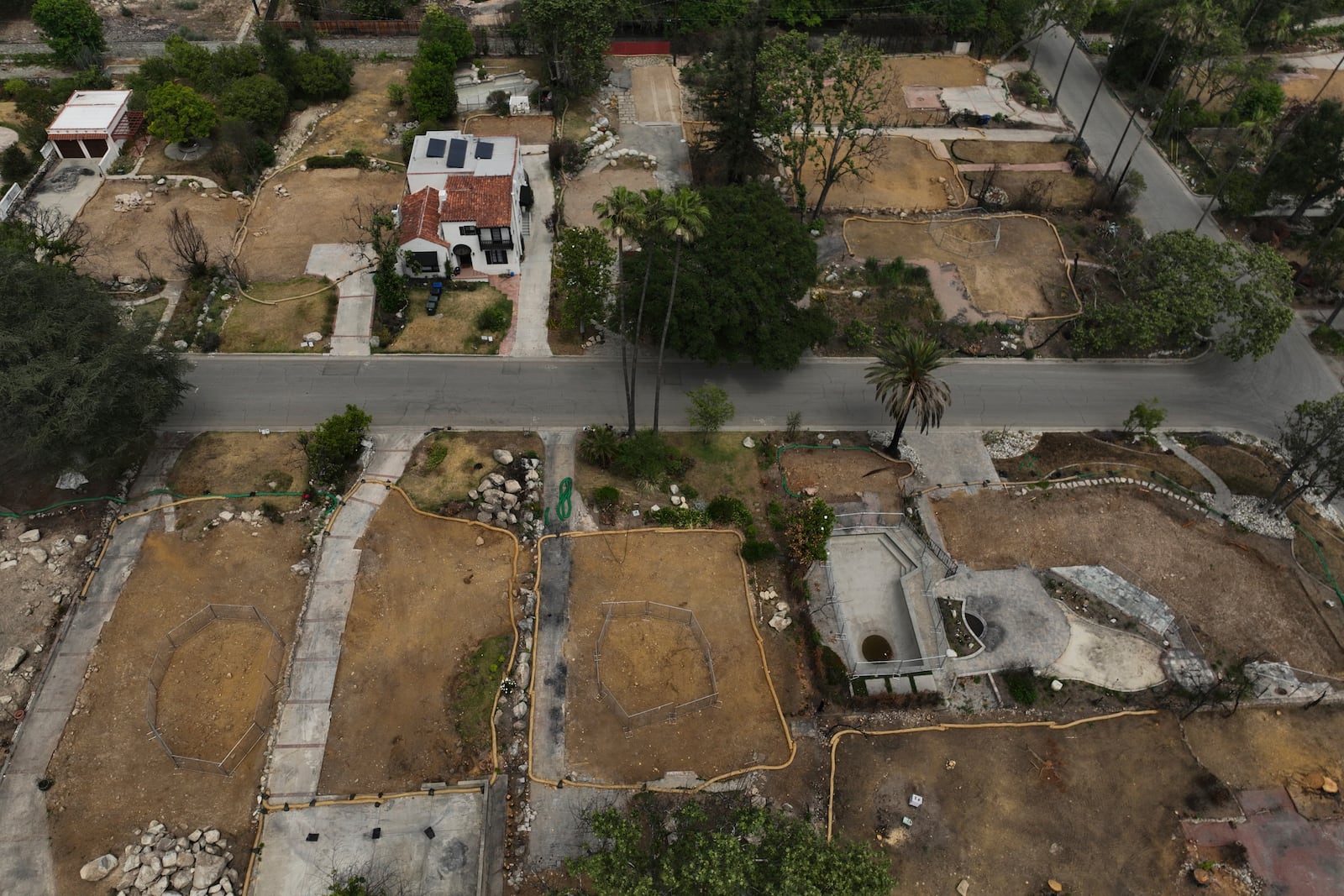 Lots sit empty after the homes were destroyed in the Eaton Fire in Altadena, Calif., Wednesday, June 4, 2025. (AP Photo/Jae C. Hong)