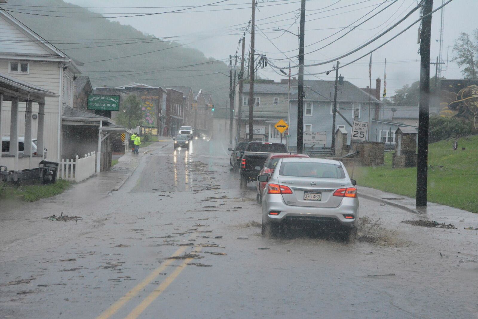 Vehicles navigate Main Street in Lonaconing, Md., Tuesday, May 13, 2025, as flash flooding occurs in the area. (Steve Bittner/Cumberland Times-News via AP)