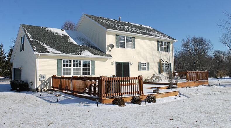 A set of French doors open to the rear deck, which spans the back of the home.