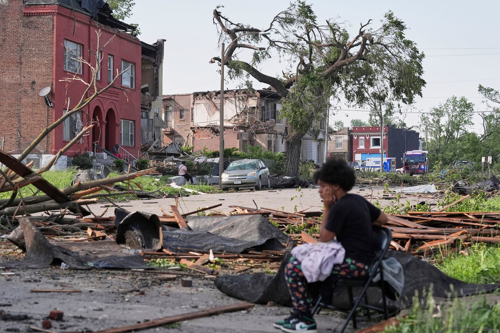 People survey damage after a severe storm moved through Friday, May 16, 2025, in St. Louis. (AP Photo/Jeff Roberson)