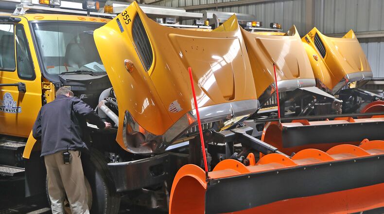 Eric Erter, Springfield Public Works superintendent, checks under the hood of one of the city's plow trucks Monday, Oct. 17, 2022. The City of Springfield has been busy attaching blades and making sure their trucks are ready for winter. BILL LACKEY/STAFF