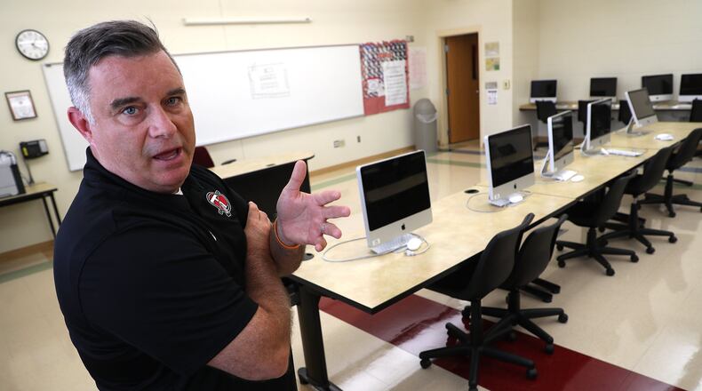 Aaron Oakes, the principal at Tecumseh High School, talks about some upgrades that will be made to the school’s IT lab with the new partnership with the University of Cincinnati’s School of Information Technology and their Early College Program. BILL LACKEY/STAFF