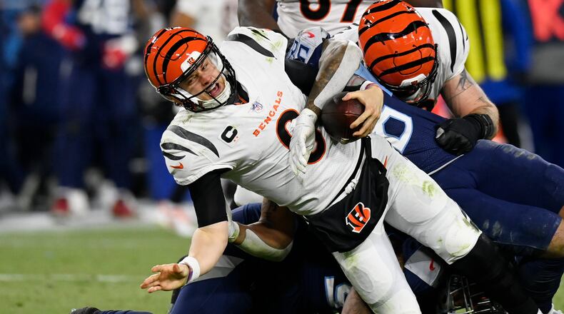 Tennessee Titans' Anthony Rush and Harold Landry sack Cincinnati Bengals quarterback Joe Burrow (9) during the second half of an NFL divisional round playoff football game, Saturday, Jan. 22, 2022, in Nashville, Tenn. (AP Photo/Mark Zaleski)