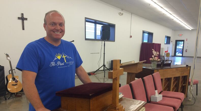 Pastor Scott Wisniewski stand at the pulpit donated to him after his church was destroyed by an explosion. KATHERINE COLLINS/STAFF