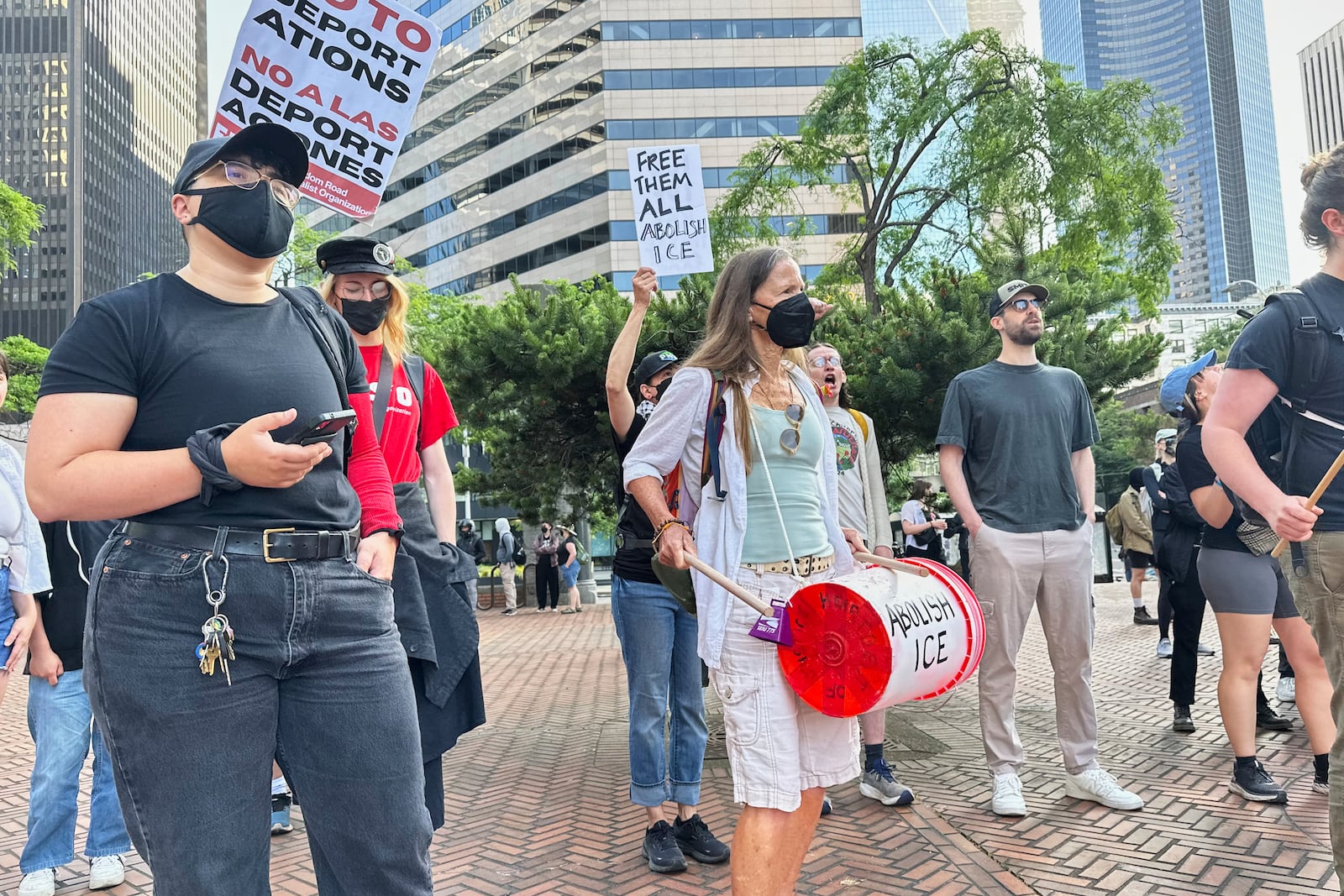 People gather outside immigration court in downtown Seattle on Tuesday, June 10, 2025, chanting with drums and holding up signs reading, “Free Them All Abolish ICE,” and “No to Deportations,” in solidarity with the protesters in Los Angeles voicing opposition to ICE arrests. (AP Photo/Martha Bellisle)