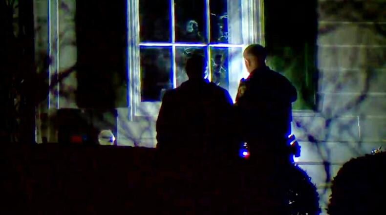 In this image taken from WCPO 9 News video shows officials inspecting broken windows and other property damage at Vice President JD Vance's Ohio home in eastern Cincinnati, Ohio, Monday, Jan. 5, 2026. (WCPO 9 News via AP)