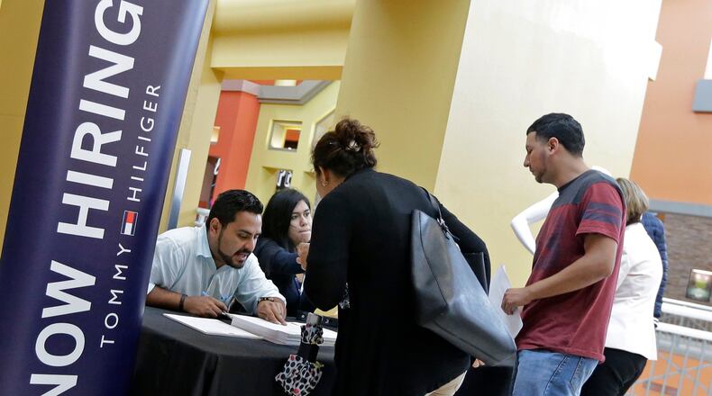 Job seekers check out a job fair in Sweetwater, Fla. in October 2017. AP Photo/Alan Diaz, File