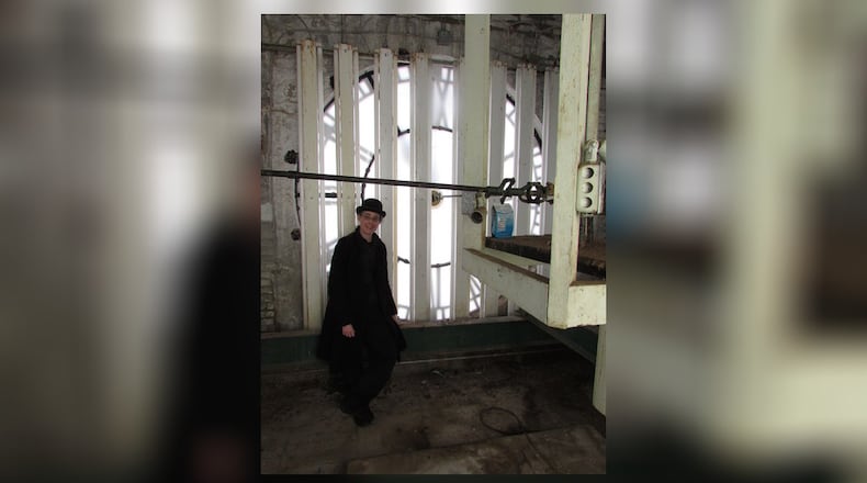 Kasey Eichensehr, a curator at the Heritage Center of Clark County, manually resets the time on the center’s clock tower for Daylight Savings Time on Sunday, March 11. Photo contributed by Pam Cottrel