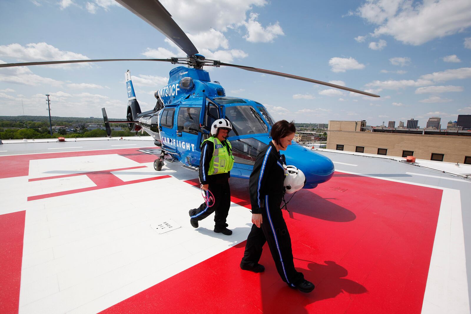 CareFlight flight nurses Stephanie Fitchpatrick, left, and Anna Houser return from a mock crash scene flight to Bradford High School which is part of the program's community outreach. TY GREENLEES / STAFF
