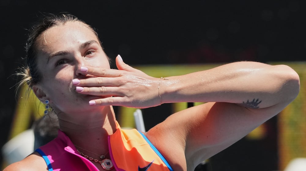 Aryna Sabalenka of Belarus celebrates after defeating Bai Zhuoxuan of China in their second round match at the Australian Open tennis championship in Melbourne, Australia, Wednesday, Jan. 21, 2026. (AP Photo/Dita Alangkara)