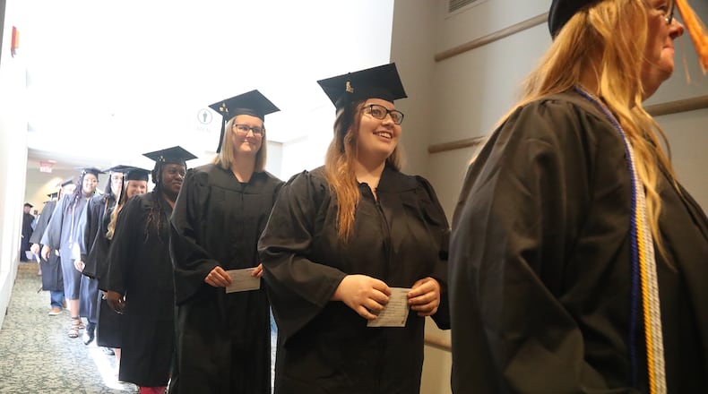 Clark State College and Wittenberg University will celebrate graduation on Saturday, May 13. Here, graduates marched into Kuss Auditorium last year for Clark State's Commencement Ceremony. FILE/BILL LACKEY/STAFF