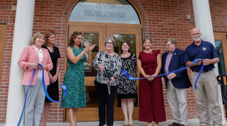 Clark County Commissioner Melanie Wilt, center left, applauds as Virginia Martycz, center, Clark County Job and Family Services former director, cuts the ribbon during the grand reopening of the $4.6M renovation project of the Home Road campus of the Clark County Department of Job and Family Services on Wednesday, Aug. 20, 2025, in Springfield. JOSEPH COOKE/STAFF