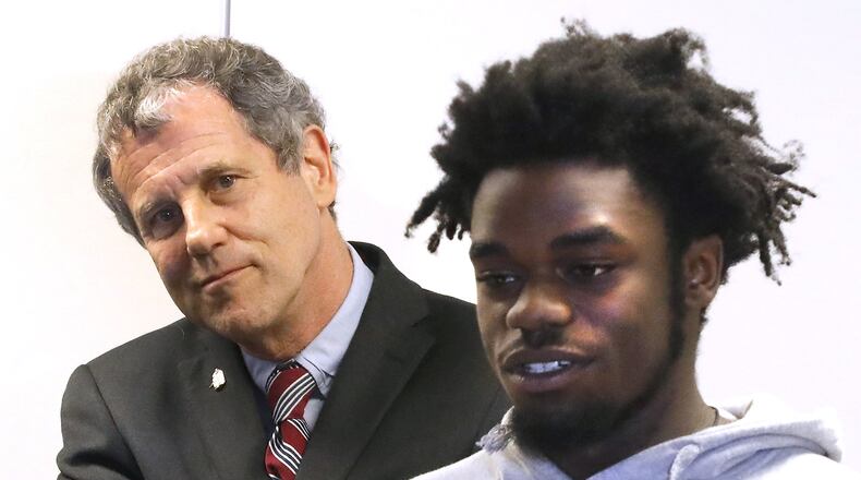Sen. Sherrod Brown listens as Lorence McNeal, 17, talks about the importance of having a mentor Friday at the Greater Springfield CareerConnectED. Brown was on hand for the launching a mentoring program called “Springfield My Brother’s Keeper.” Bill Lackey/Staff