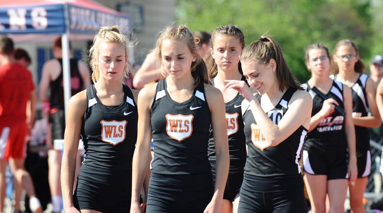 West Liberty-Salem’s 3,200-meter relay team of (from left) Grace Adams, Megan Adams, Madison Bahan and Katelyn Stapleton set a school record while winning the event at the Division III district meet Tuesday. Greg Billing / Contributed