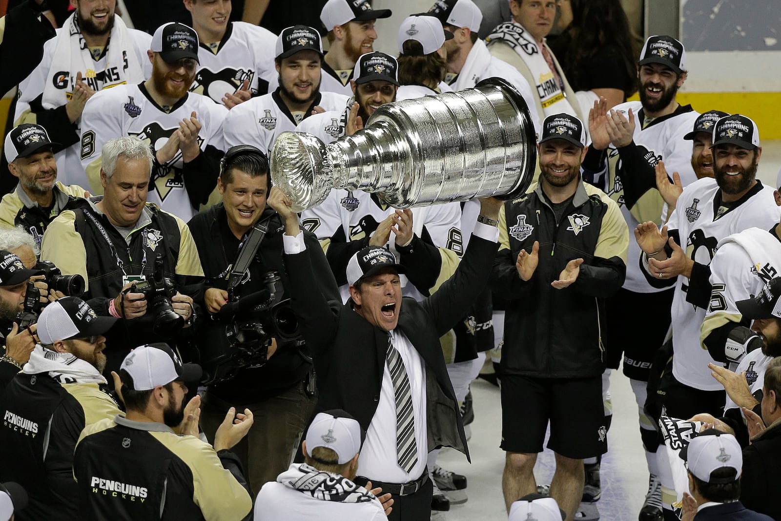 FILE - Pittsburgh Penguins head coach Mike Sullivan raises the Stanley Cup after Game 6 of the NHL hockey Stanley Cup Finals against the San Jose Sharks in San Jose, Calif, June 12, 2016. (AP Photo/Eric Risberg, File)