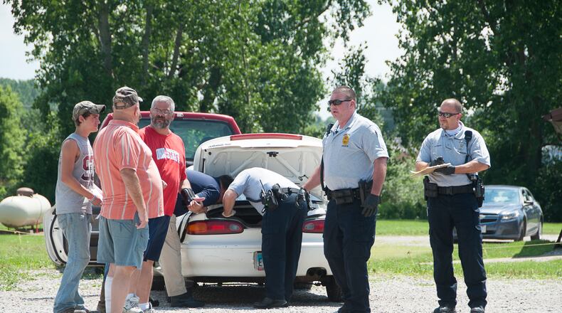 Investigators from Shelby police and the Ohio BCI the copy paper type box contain a rug with the body of a dead new born baby in it at 261 N. Gamble Street in Shelby. DAVID POLCYN / MANSFIELD NEWS JOURNAL
