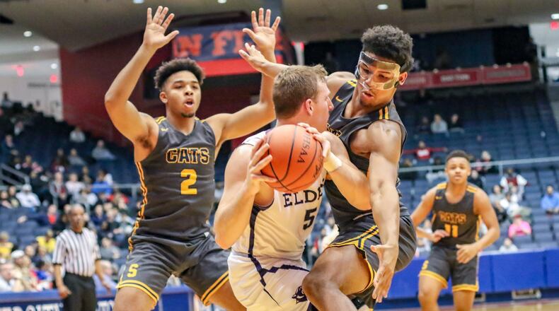 Springfield’s Jalan Minney (right) and Jordan Howard (2) trap Elder’s Michael Bittner during a Division I district final game on Saturday night at the University of Dayton Arena. The Wildcats won 55-35. CONTRIBUTED PHOTO BY MICHAEL COOPER