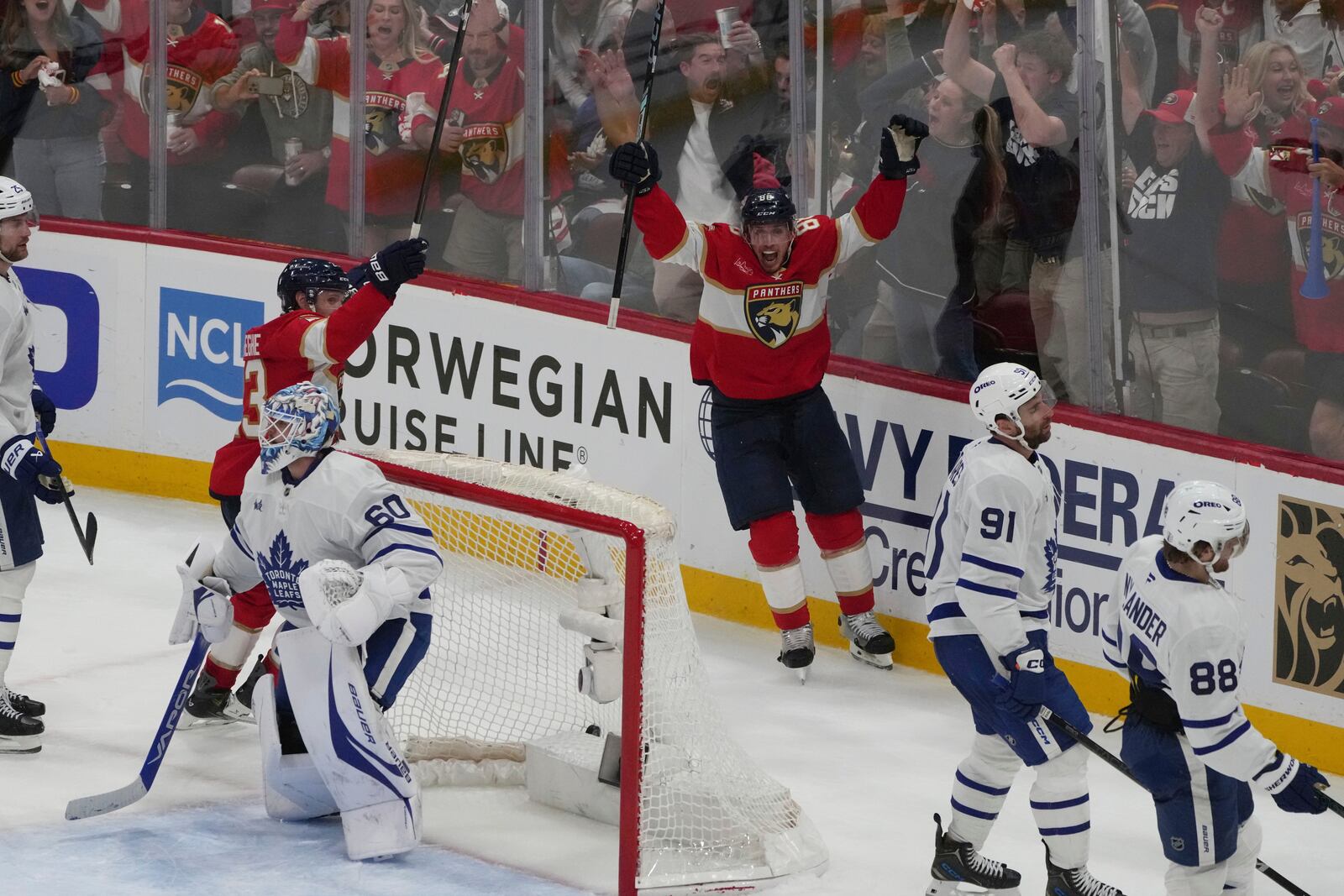 Florida Panthers center Carter Verhaeghe (23) celebrates after Brad Marchand (63) scored the winning goal in overtime in Game 3 of a second-round NHL hockey playoff series against the Toronto Maple Leafs, Friday, May 9, 2025, in Sunrise, Fla. (AP Photo/Marta Lavandier)