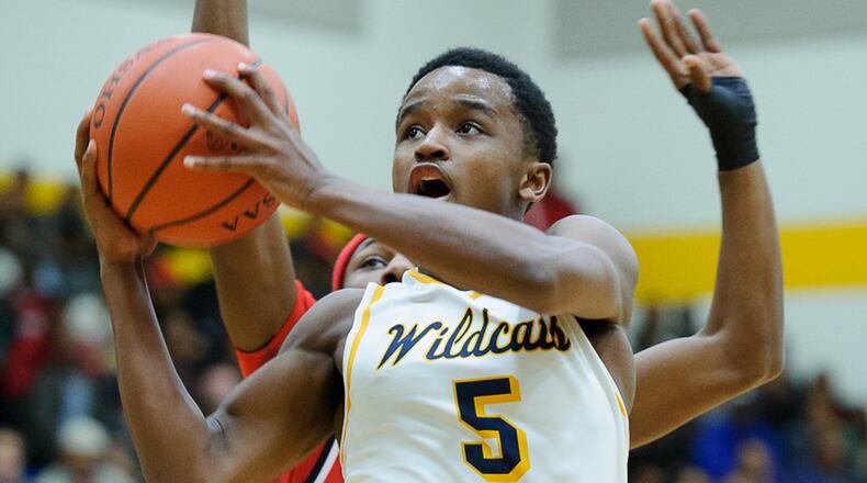 Springfield junior guard Michael Wallace shoots with pressure from Trotwood’s Carl Blanton during a game on Friday night. Bryant Billing/Contributed