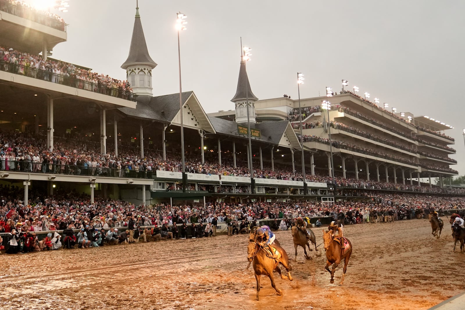 Sovereignty, left, ridden by Junior Alvarado, crosses the finish line to win the 151st running of the Kentucky Derby horse race at Churchill Downs Saturday, May 3, 2025, in Louisville, Ky. (AP Photo/Abbie Parr)