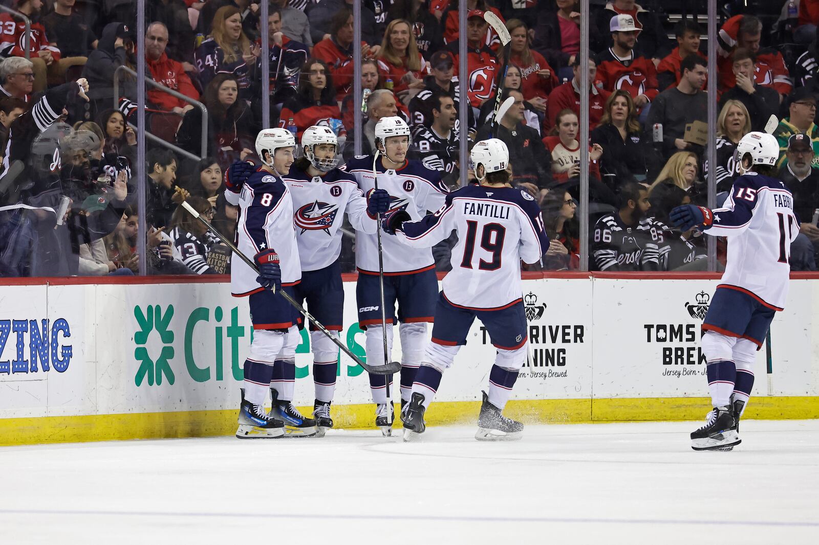 Columbus Blue Jackets right wing Kirill Marchenko, second left, is congratulated by teammates after scoring a goal during the second period of an NHL hockey game against the New Jersey Devils, Tuesday, March 11, 2025, in Newark, N.J. (AP Photo/Adam Hunger)