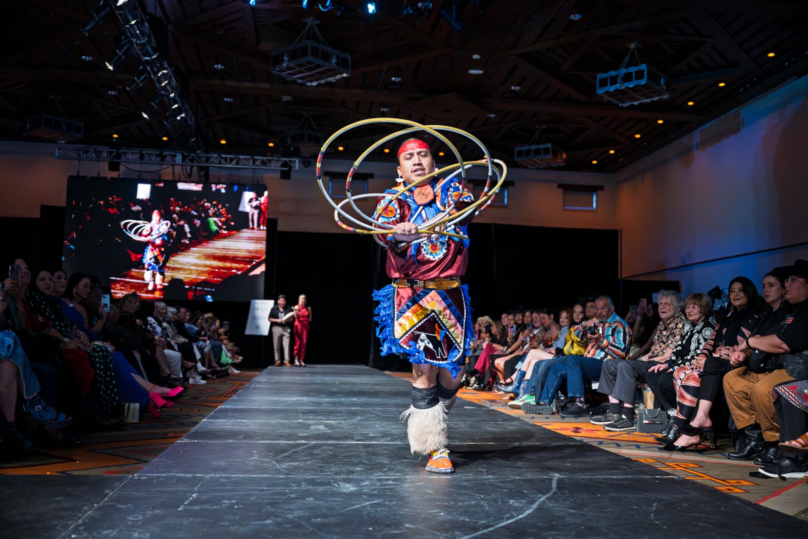 Kevin Dakota Duncan, of Phoenix, performs a hoop dance before models take to the runway at the 2025 Native Fashion Show, Friday, May 9, 2025, in Santa Fe, N.M. (AP Photo/Roberto E. Rosales)