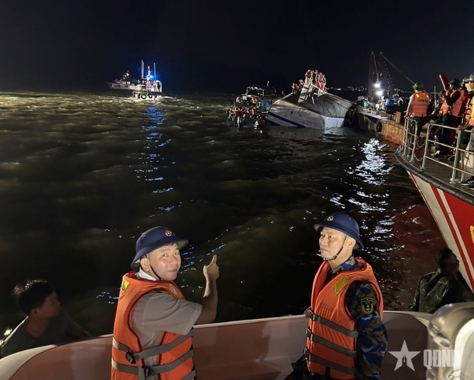 This image from a video provided by QDND shows rescue workers searching for people after a tourist boat capsized in Ha Long Bay, Vietnam on Saturday, July 19, 2025. (QDND via AP)