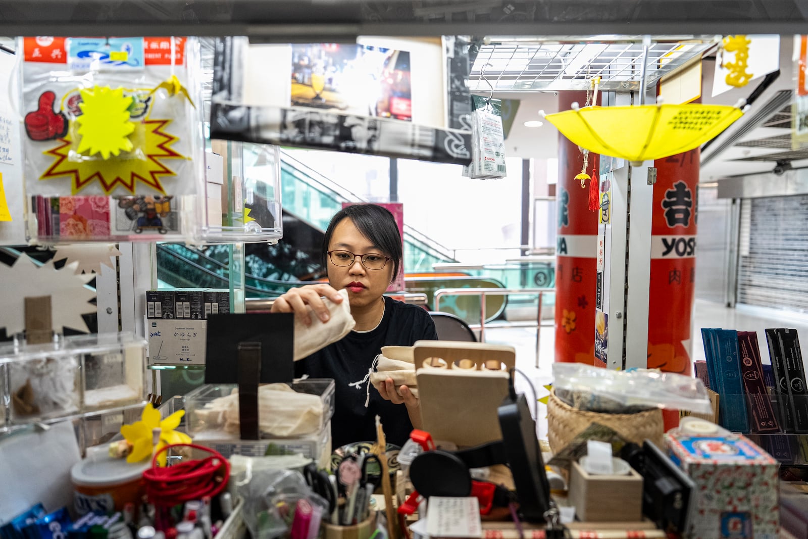 Chan Kim Kam, former pro-democracy district councillor, works at her stall selling incense and essential oils in Hong Kong, Friday, June 20, 2025. (AP Photo/Chan Long Hei)