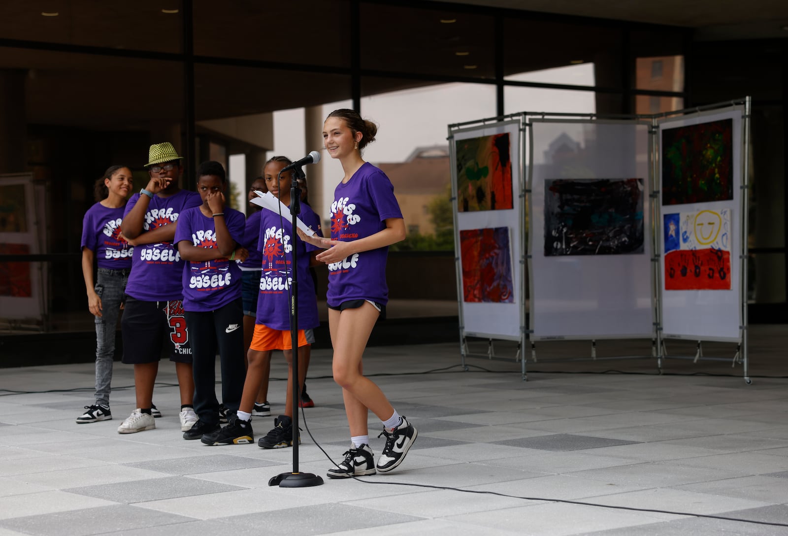 A kid reads a poem for an audience during Project Jericho Summer Arts Camp on Friday, June 13, 2025, at City Hall Plaza. JOSEPH COOKE/STAFF