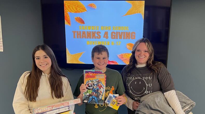 Shawnee High School is hosting a Thanks 4 Giving donation drive for staff and students to bring in items to donate to two local organizations who provide resources and support to Clark County residents. In this photo is Reese Chilcote (left), Evan Brown (middle) and Olivia Lemon (right). Contributed
