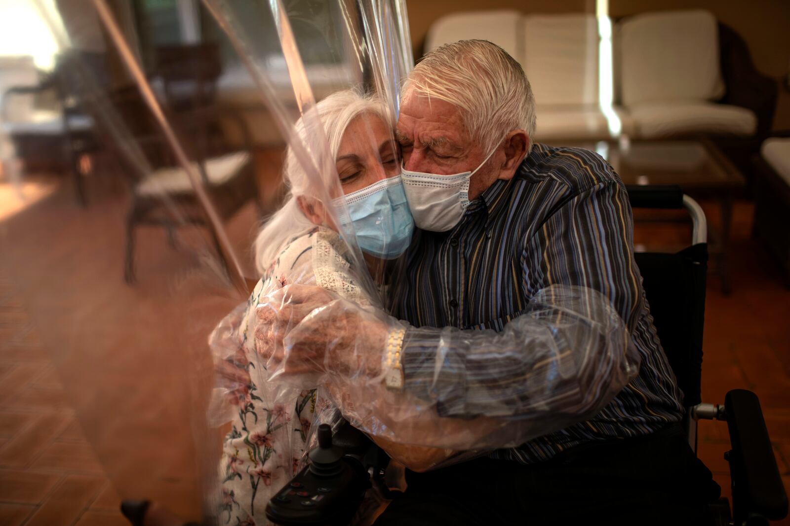 FILE - Dolores Reyes Fernández, 61, hugs her father, José Reyes Lozano, 87, for the first time in nearly four months as visits resume at the nursing home in Barcelona, Spain, Monday, June 22, 2020. (AP Photo/Emilio Morenatti, File)