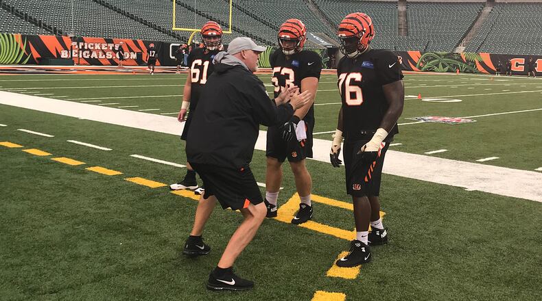 Bengals offensive line coach Frank Pollack goes over technique with several players during Saturday’s practice at Paul Brown Stadium. JAY MORRISON/STAFF