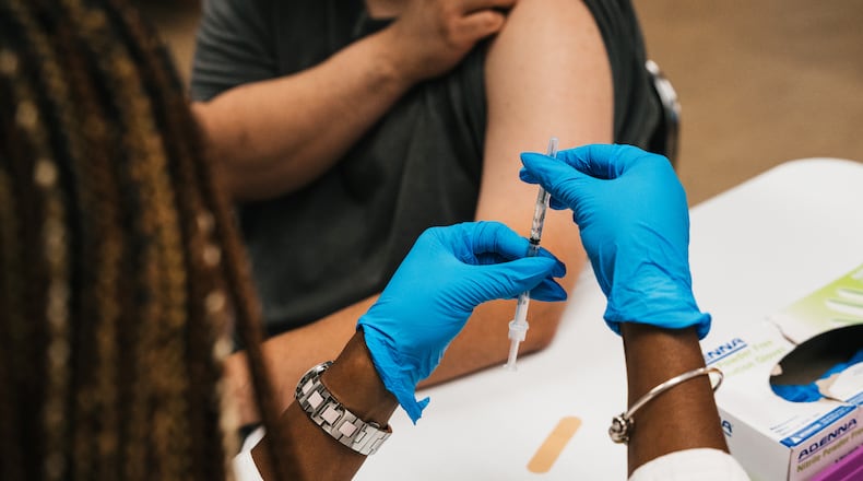 FILE — A registered nurse prepares the COVID booster at a vaccine and booster event at the Quinn Center in Maywood, Ill., on Sept. 13, 2022. A committee of advisers to the Food and Drug Administration voted on Wednesday, June 5, 2024, to update the formula for the COVID-19 vaccine ahead of an anticipated fall immunization campaign, now an annual step to try to offer better protection against versions of the virus in circulation. (Jamie Kelter Davis/The New York Times)