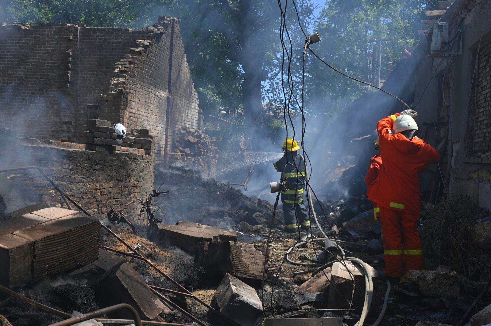 Emergency services personnel work to extinguish a fire following a Russian attack in Odesa, Ukraine, Friday, July 11, 2025. (AP Photo/Michael Shtekel)