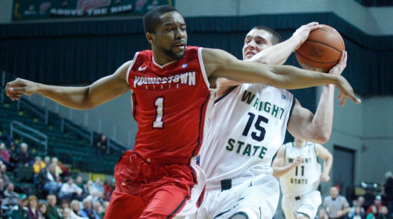 Wright State guard Kendall Griffin, left, drives to the basket in the first half on Saturday at the Nutter Center. David Jablonski/Staff