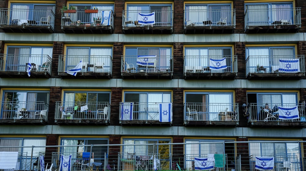 FILE - Israeli flags decorate rooms of Israelis who evacuated from cities and towns along the border with Lebanon, in kibbutz Ginosar hotel, northern Israel, Tuesday, March 5, 2024. (AP Photo/Ariel Schalit, file)
