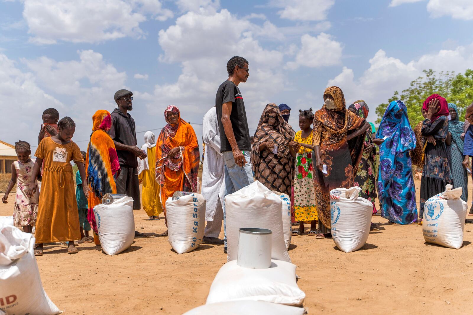 This June 2023 photo provided by the World Food Program shows food distribution by the WFP for internally displaced persons at the Wad Almajzoub farm camp in Wad Medani, Gezira state, Sudan. (Ala Kheir/U.N. Office for the Coordination of Humanitarian Affairs via AP)